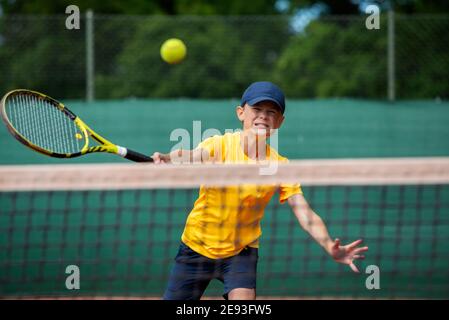 Boy playing tennis Stock Photo