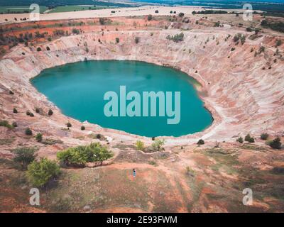 Aerial view of woman photographer doing photos in font of copper mine Stock Photo