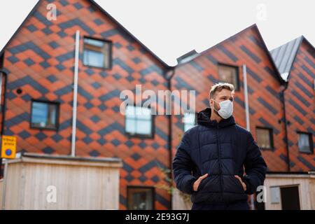 Man wearing face mask looking away Stock Photo