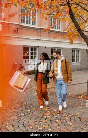 Young couple walking with shopping bags Stock Photo