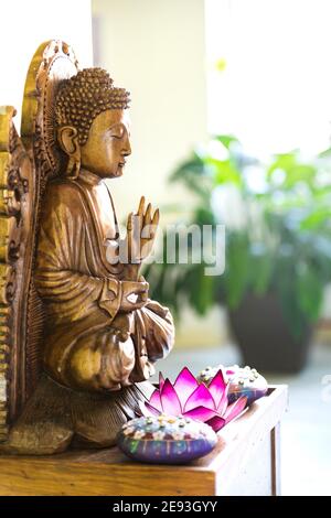 Buddah statue at home. Interior design peacefull and healthy. Sweet home. Stock Photo
