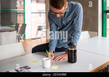 Man doing notes in meeting room Stock Photo