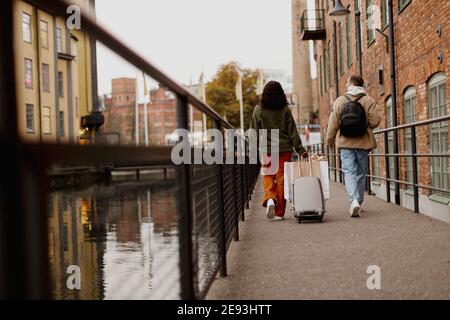 Couple walking along canal in town Stock Photo
