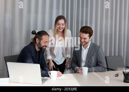 Coworkers talking in boardroom Stock Photo