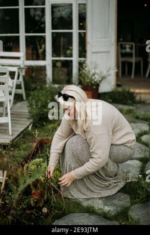 Woman taking care of plants in garden Stock Photo