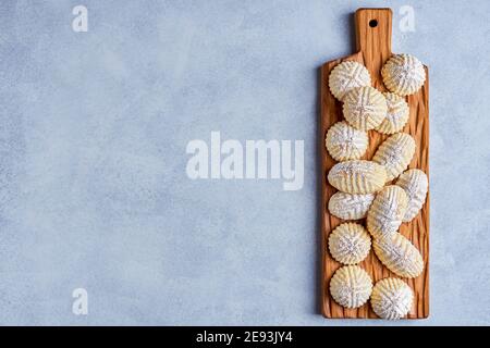 Arabic sweets. Traditional eid semolina maamoul or mamoul cookies with dates , walnuts and pistachio nuts . Top view, copy space Stock Photo