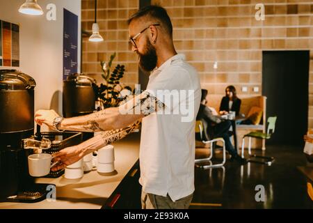 Businessman having coffee break in new company Stock Photo