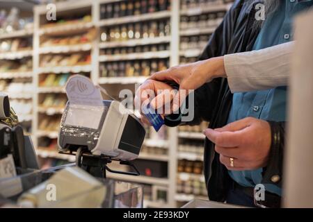 Close-up of hands using credit card reader Stock Photo
