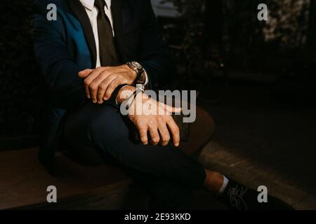 Low section of businessman sitting outdoors Stock Photo