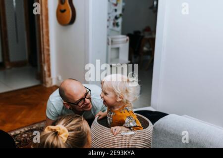 Happy toddler boy sitting in basket Stock Photo
