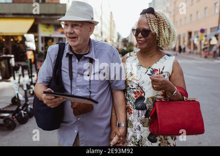 Happy senior couple walking in city Stock Photo