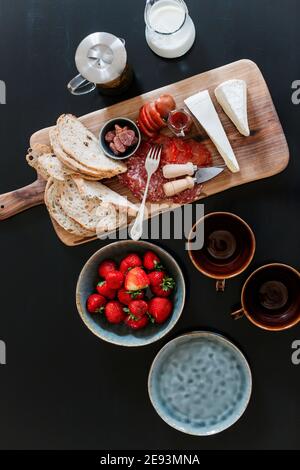 High angle view of cheese and meat on wooden board Stock Photo