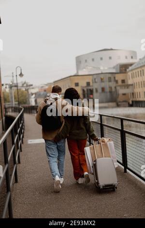 Couple walking along canal in town Stock Photo