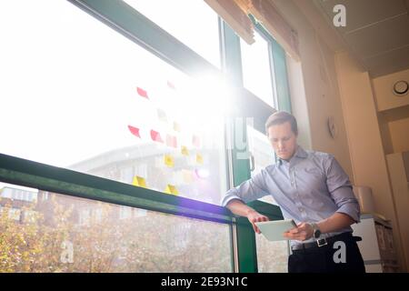 Man standing against window Stock Photo
