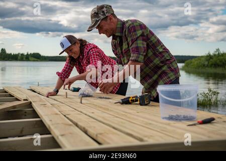 Smiling couple doing carpentry Stock Photo
