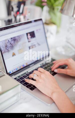 Womans hand on laptop keyboard Stock Photo