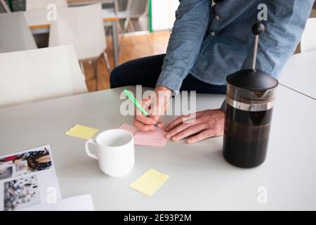 Mid section of man doing notes in meeting room Stock Photo