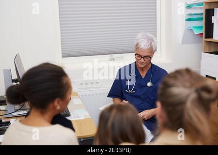Family visiting doctor in health center Stock Photo