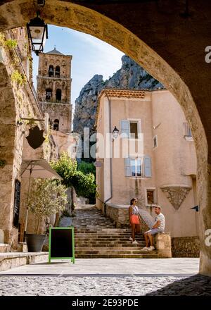 The Village of Moustiers-Sainte-Marie, Provence, France Europe, a colorful village in the Provence France, couple on vacation in France, mid age men and woman visiting Moustiers-Sainte-Marie Stock Photo