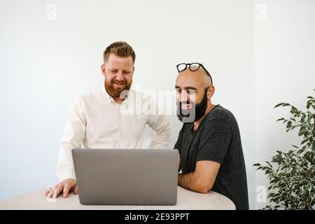 Men using laptop in office Stock Photo