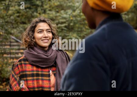 Two young women talking in park Stock Photo
