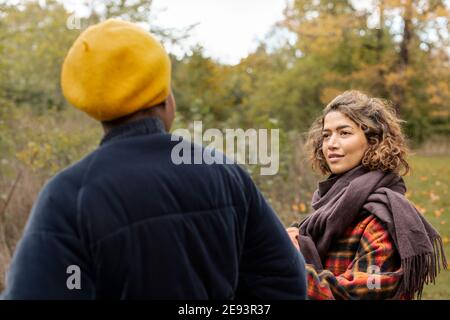 Two young women talking in park Stock Photo