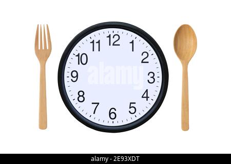 Watches without long and short hands with spoon and fork on white background. Stock Photo