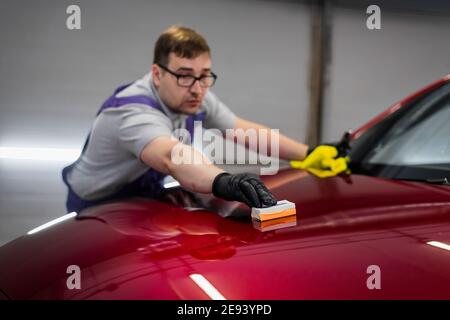 Car Service Worker Applying Nano Coating On A Car Detail Stock Photo,  Picture and Royalty Free Image. Image 152199256.