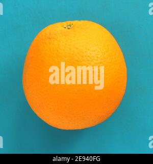 Close up of orange citrus on blue background. Bright orange citrus, fresh summer mood. Stock photo blank for your design.  Stock Photo