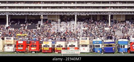 Derby Day horse racing event a historical archival image of long row & back view of double decker open top tour buses on hire to 80s Derby race spectators parked on the Epsom downs beside the racecourse opposite the main spectator stand for their grandstand view of the famous iconic horse race a historical archive image1980s the way we were in England UK Stock Photo