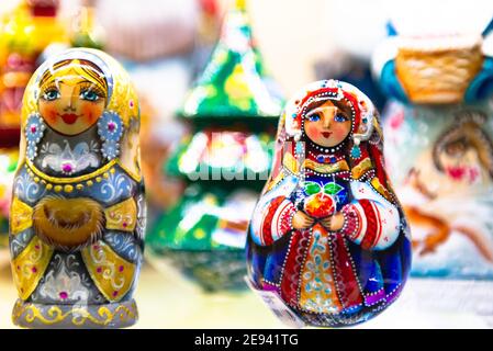 Bright matryoshka dolls on display. Two nesting dolls are brightly lit. Stock Photo