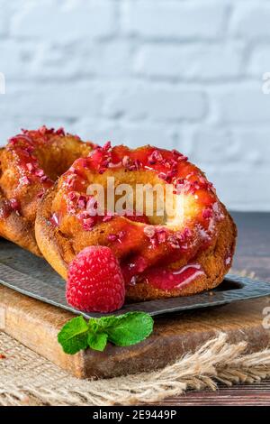 Mini vanilla pound cakes with raspberry icing Stock Photo