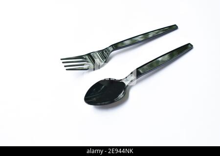 black plastic spoon and fork for single used on white background Stock Photo