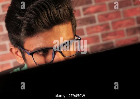 serious young asian man working on laptop with copy space  Stock Photo