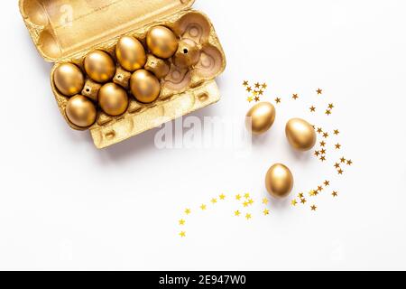 Golden Easter eggs in box cells. Save money. Symbol of wealth and good luck Stock Photo