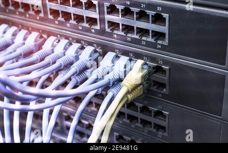 network cable connecting on network core switch close up Stock Photo