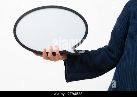 Close up of person holding blank speech bubble on white background. Communication and dialogue. Stock Photo