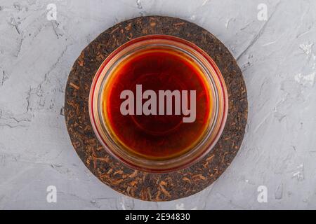 Pu erh tea cake and chinese tea cup on plaster background Stock Photo