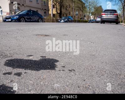 Oil leakage from old car on the Street Stock Photo