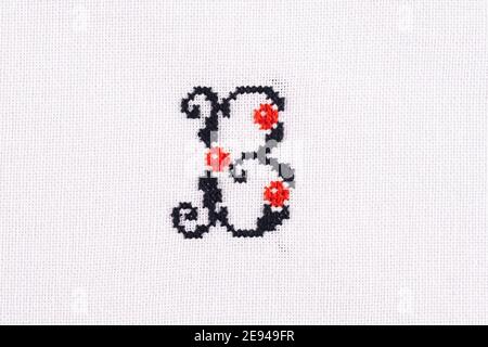 Letter B of Embroidered Cross - Stitch Latin Alphabet on White Linen Fabric Background Handmade Close-up Stock Photo