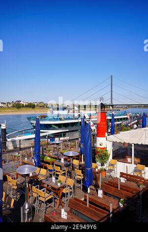 Restaurant exterior at the popular Rhine river promenade on a beautiful sunny day. Stock Photo