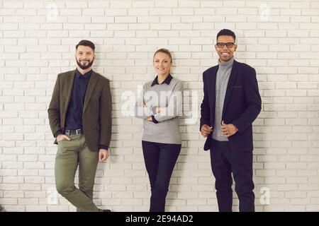Group of smiling young diverse colleagues, company managers or business partners Stock Photo