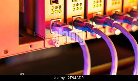 network cable connecting on network core switch close up Stock Photo