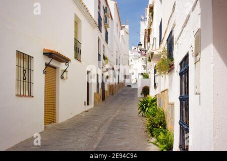 View of a street that rises to the upper area of the historic center of Casares, with its narrow streets and whitewashed houses. Casares, Andalucia, Stock Photo