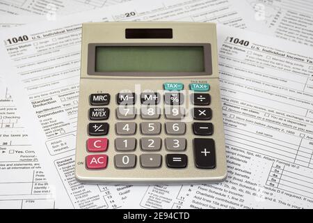 calculator with blank screen on 2020 Internal Revenue Service 1040 tax forms Stock Photo