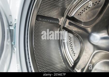 Clean Stainless Steel Laundry Machine Drum Close Up. Washing Technologies and Equipment Maintenance. Stock Photo