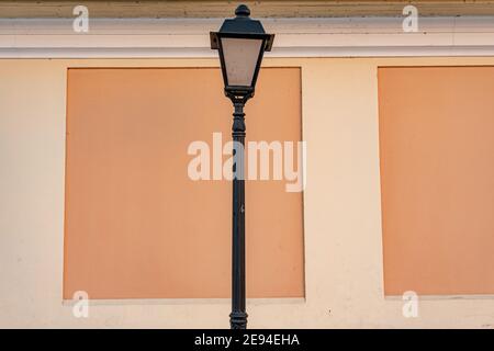 Urban vintage lantern against the background of an orange wall, cozy European streets Stock Photo