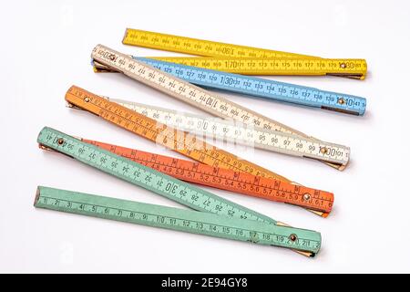 Vintage multicolored wooden folding ruler isolated on a white background