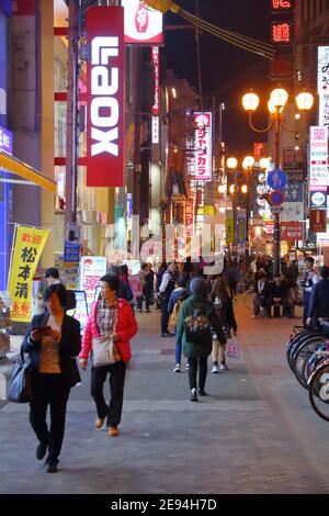 OSAKA, JAPAN - NOVEMBER 21, 2016: People visit night Dotonbori street in Osaka, Japan. Dotonbori is the main entertainment area of Osaka. Stock Photo