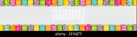 Easter banner with colorful Easter Egg double border over a white background. Above view with copy space. Stock Photo